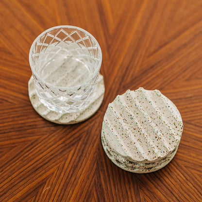 Terrazzo concrete coaster set in white. Seen on coffee table with fancy glass. Sold in set of 2 or 4.