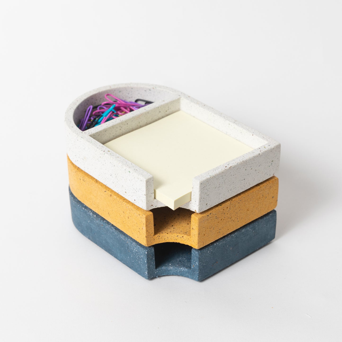 Concrete sticki note holder in various colors.