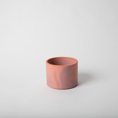 4 inch concrete vessel with cork base in coral and mauve.