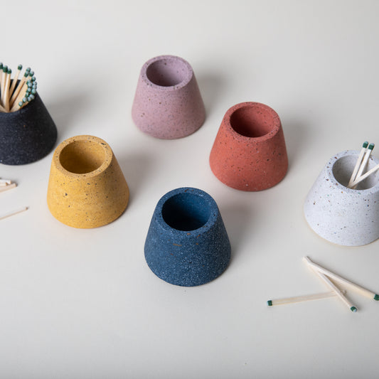 Concrete terrazzo matchstick holder in various colors.