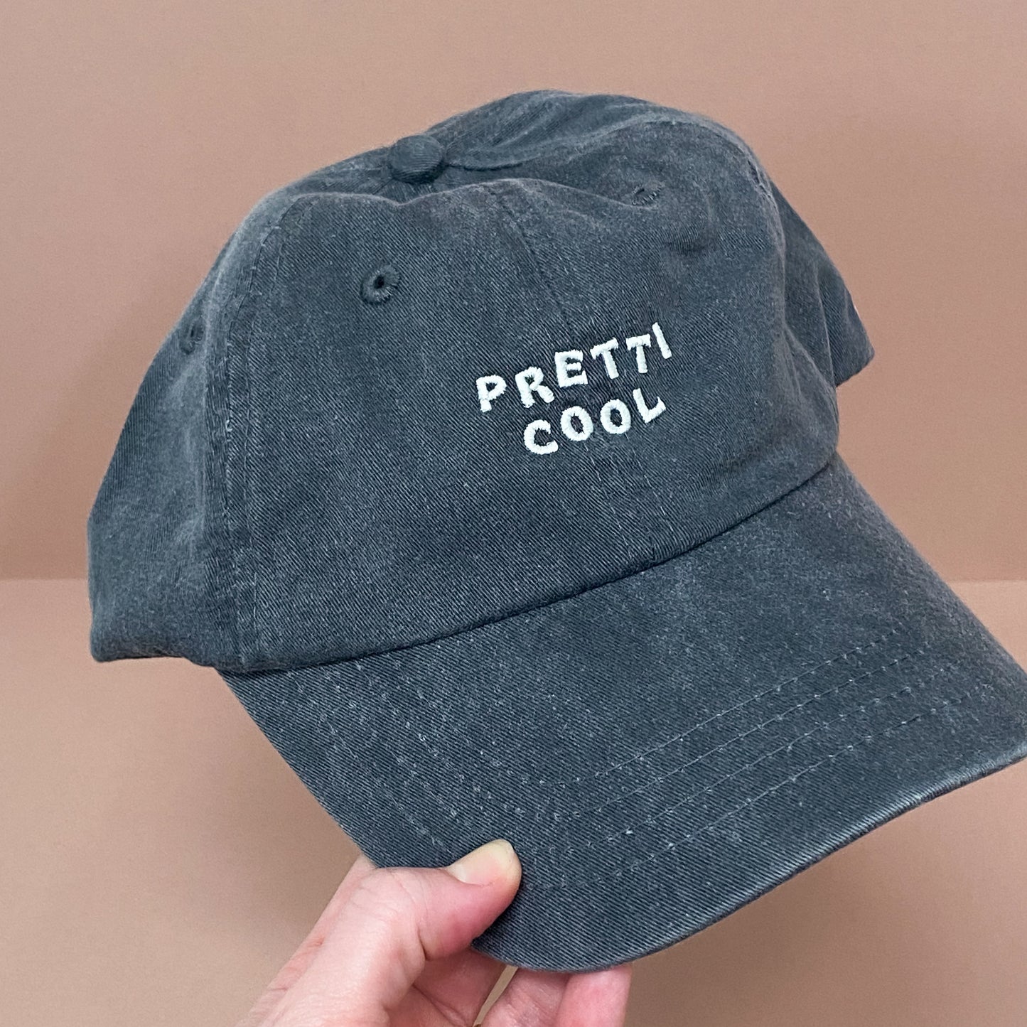 Pretti.Cool dad hat in faded black w/ cream embroidery.