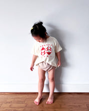 Geo Toddler Tee on Sophie in Cream w/ Red/Orange