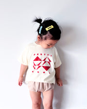 Geo Toddler Tee on Sophie in Cream w/ Red/Orange