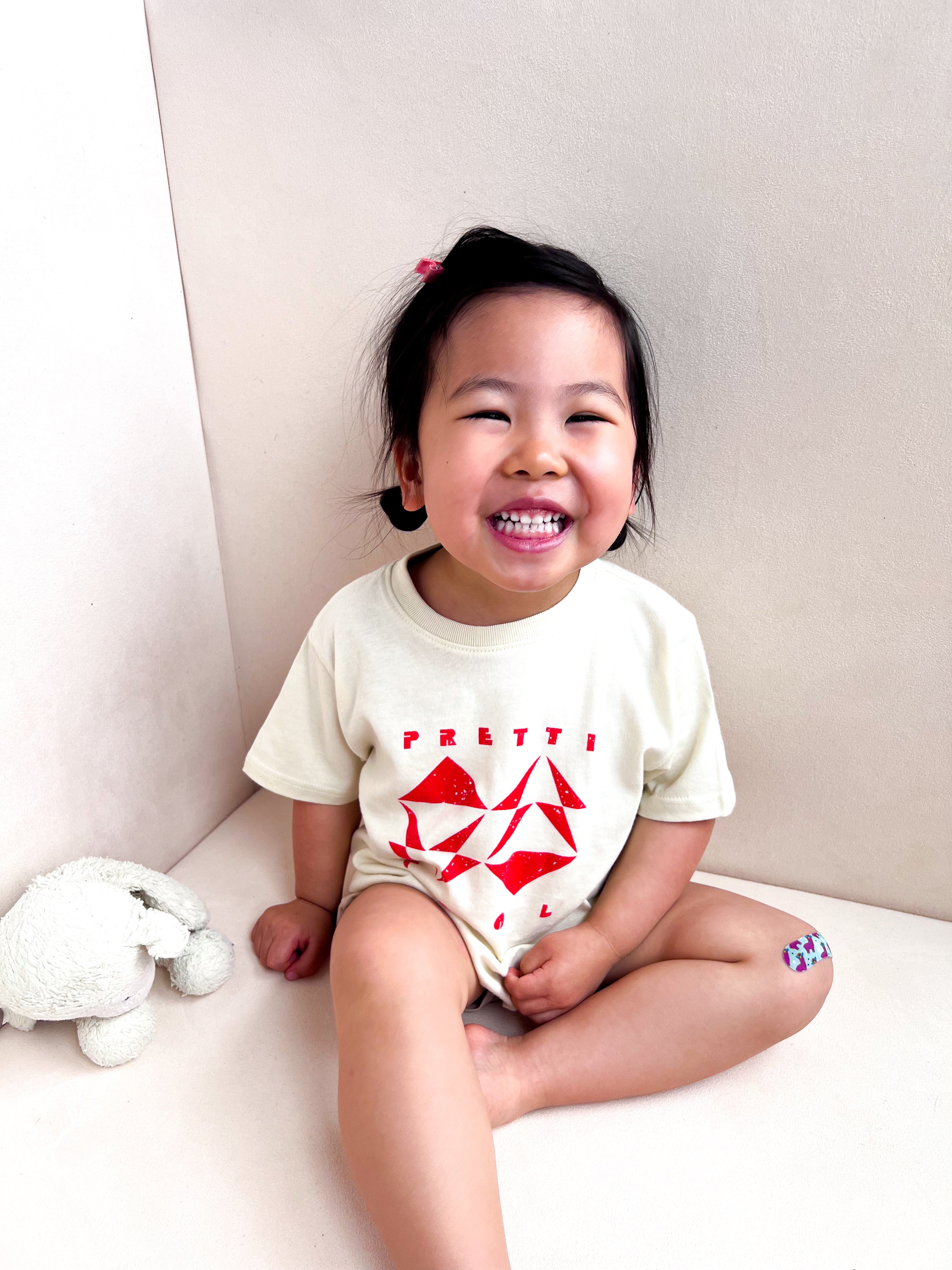 Geo Toddler Tee on Sophie in Cream w/ Red/Orange