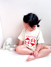 Geo Toddler Tee on Sophie in Cream w/ Red/Orange