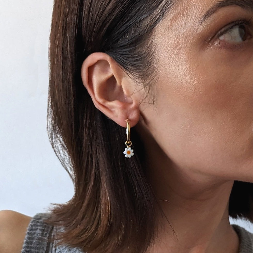 Gold Fill Daisy Charm Hoop Earrings on a model.