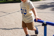 Geo Toddler Tee on Aaron in Cream w/ Cobalt