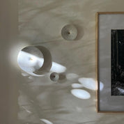 Dimple Wall Hooks in White Terrazzo, shown hanging on a wall.