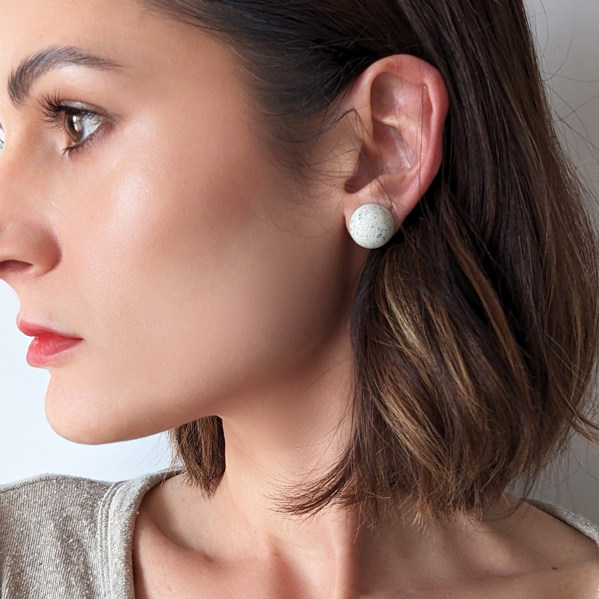 Pretti.Cool's Dome Earrings in White Terrazzo on a model.