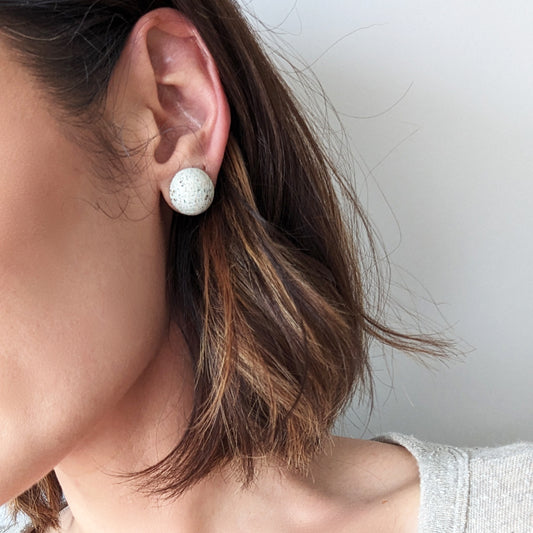 Pretti.Cool's Dome Earrings in White Terrazzo on a model.