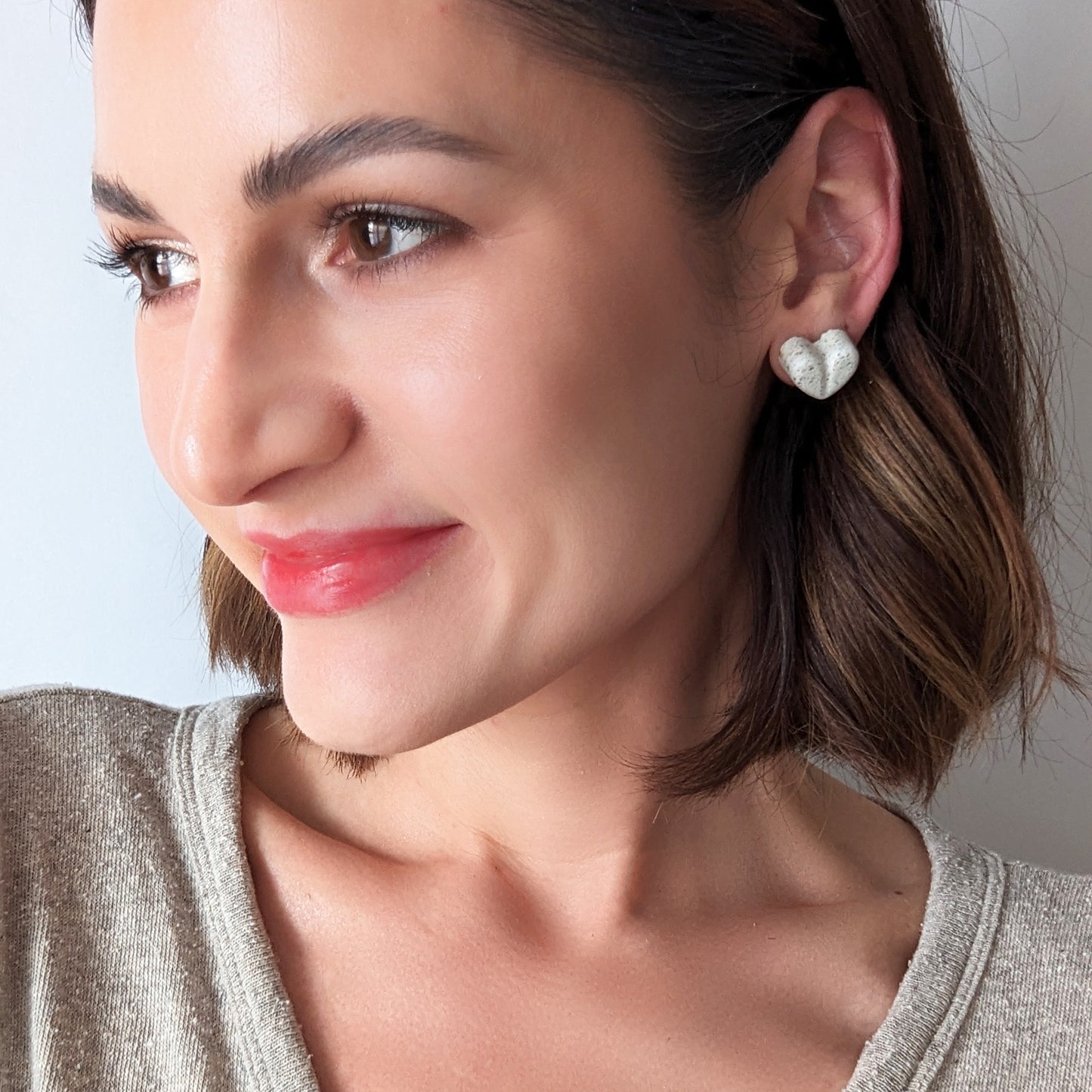 Pretti.Cool's Chunky Heart Earrings in White Terrazzo on a model.