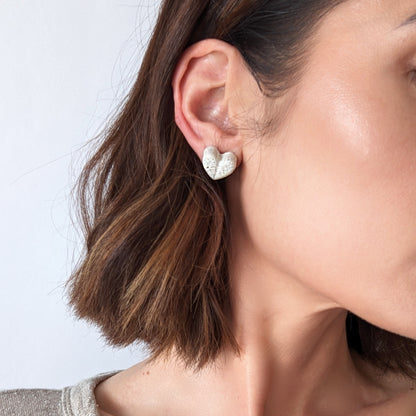 Pretti.Cool's Chunky Heart Earrings in White Terrazzo on a model.