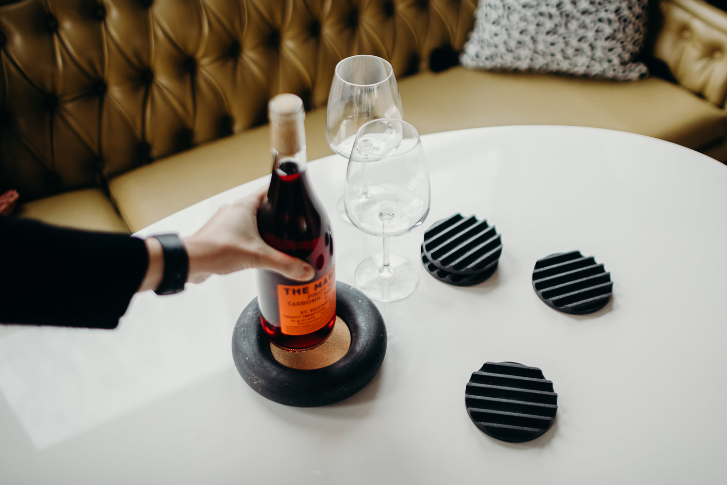 black terrazzo wine bottle coaster + drink coasters, styled on a table