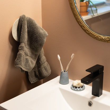 Toothbrush Holder in Light Blue Terrazzo, styled by a sink.