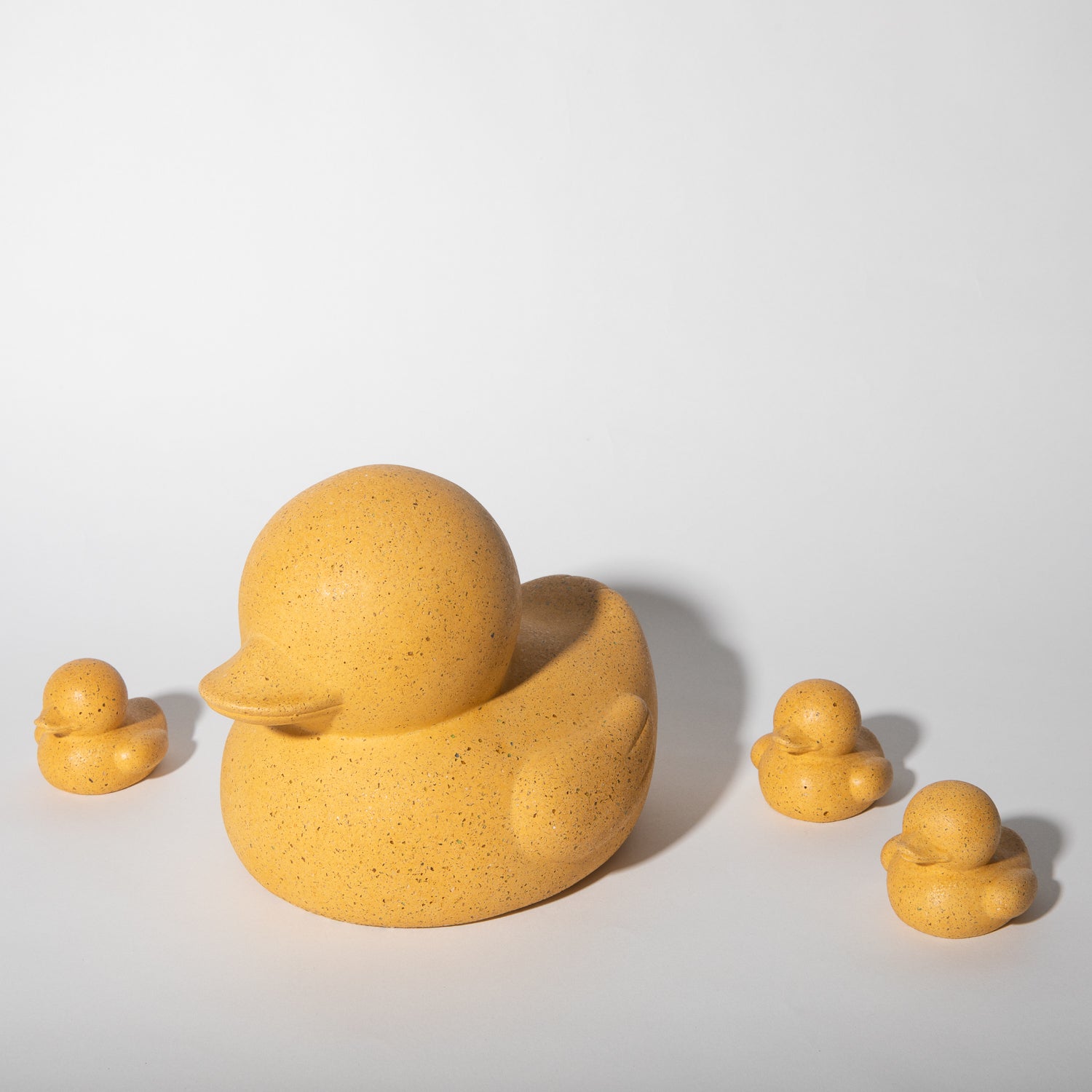 Large and mini "rubber" duckies in marigold terrazzo.