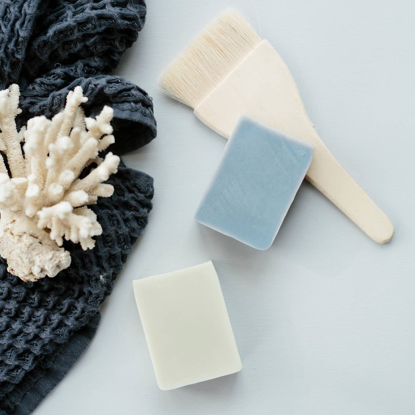 Bell Mountain Naturals' soap bars in a few different scents, shown next to a towel.