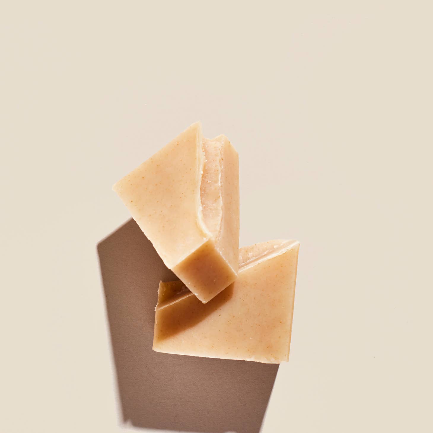 Palermo's Coconut Milk + Oatmeal soap bar, shown broken in half.