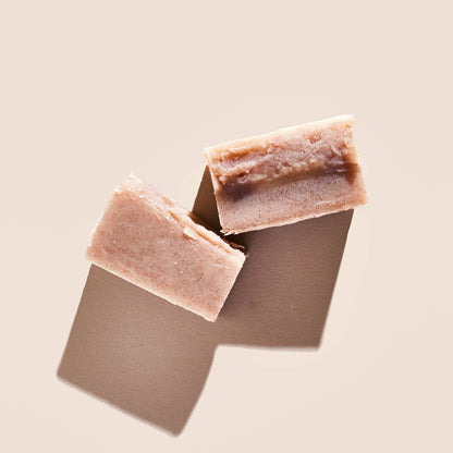 Palermo's Rose Geranium + Mandarin soap bar, shown broken in half.