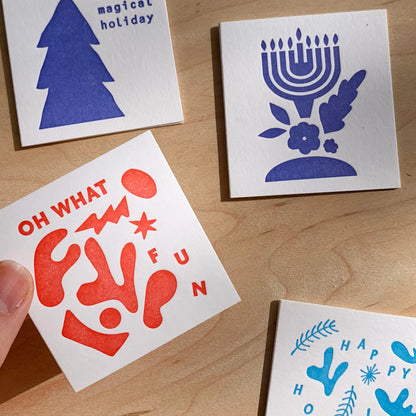 Meshworks Press Products Happy Hanukkah Mini Card, next to a hand for scale