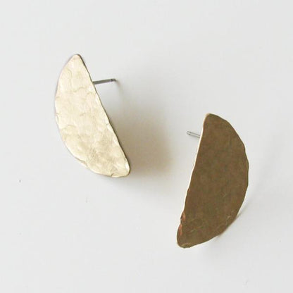 Hammered brass half moon stud earrings with sterling silver posts.