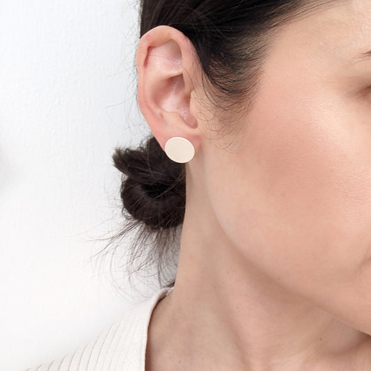 Round Brass earrings w/ Sterling Posts on woman.