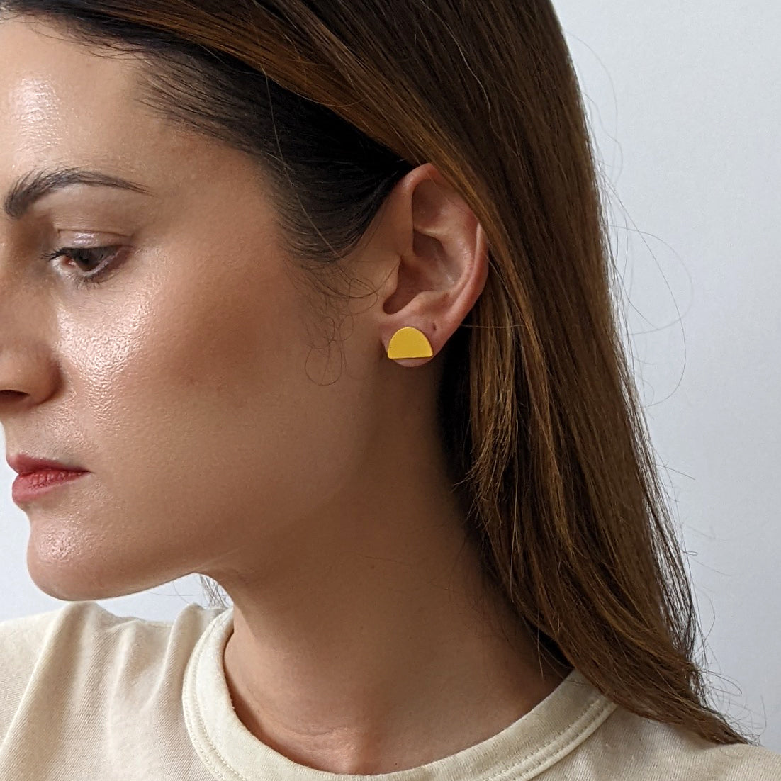 Mound Earrings in marigold, styled on model.