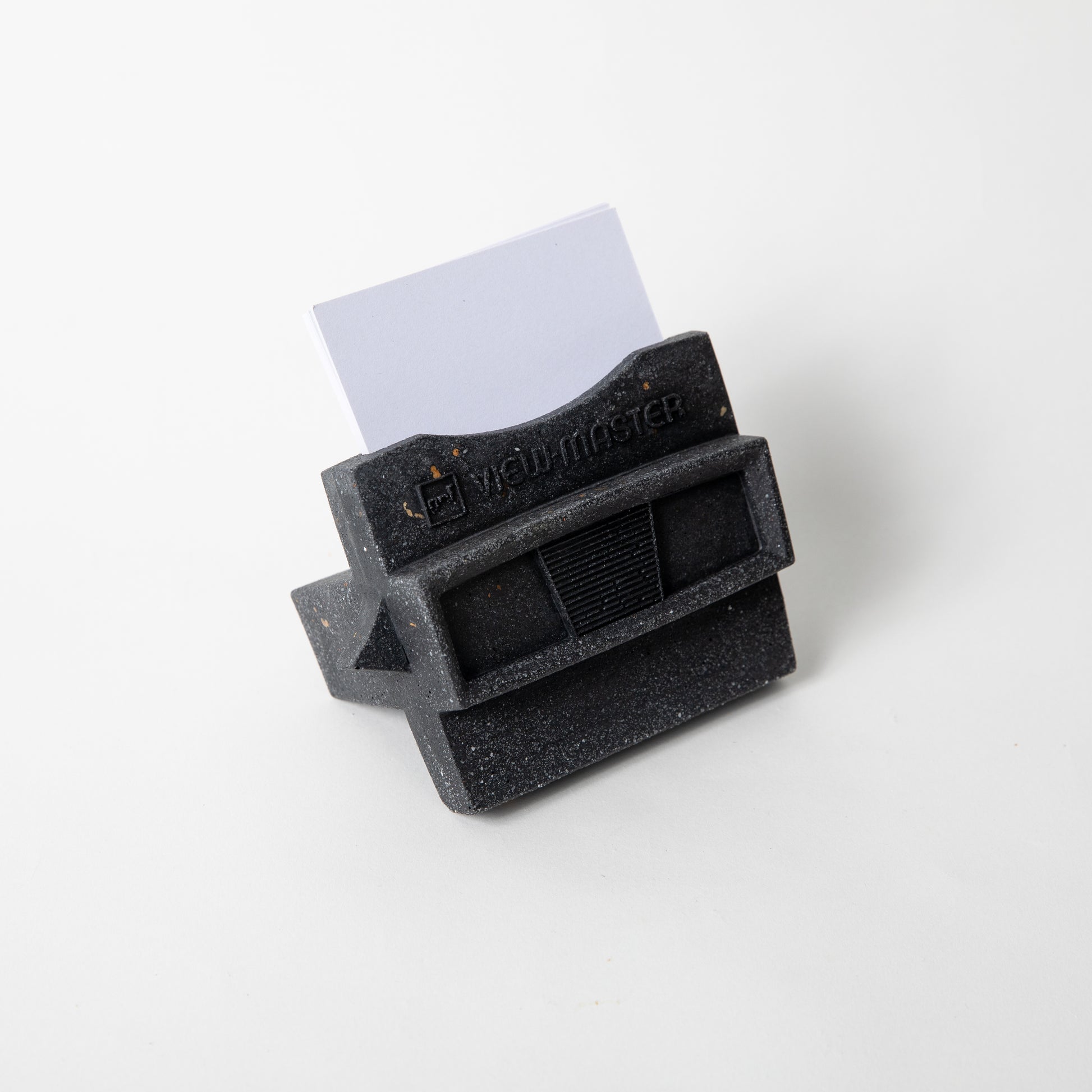 The Retro Business Card Holder in Black Terrazzo w/ blank business cards placed inside.