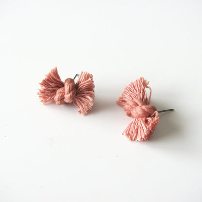 Dyed cotton rope knot earrings with titanium post in coral.