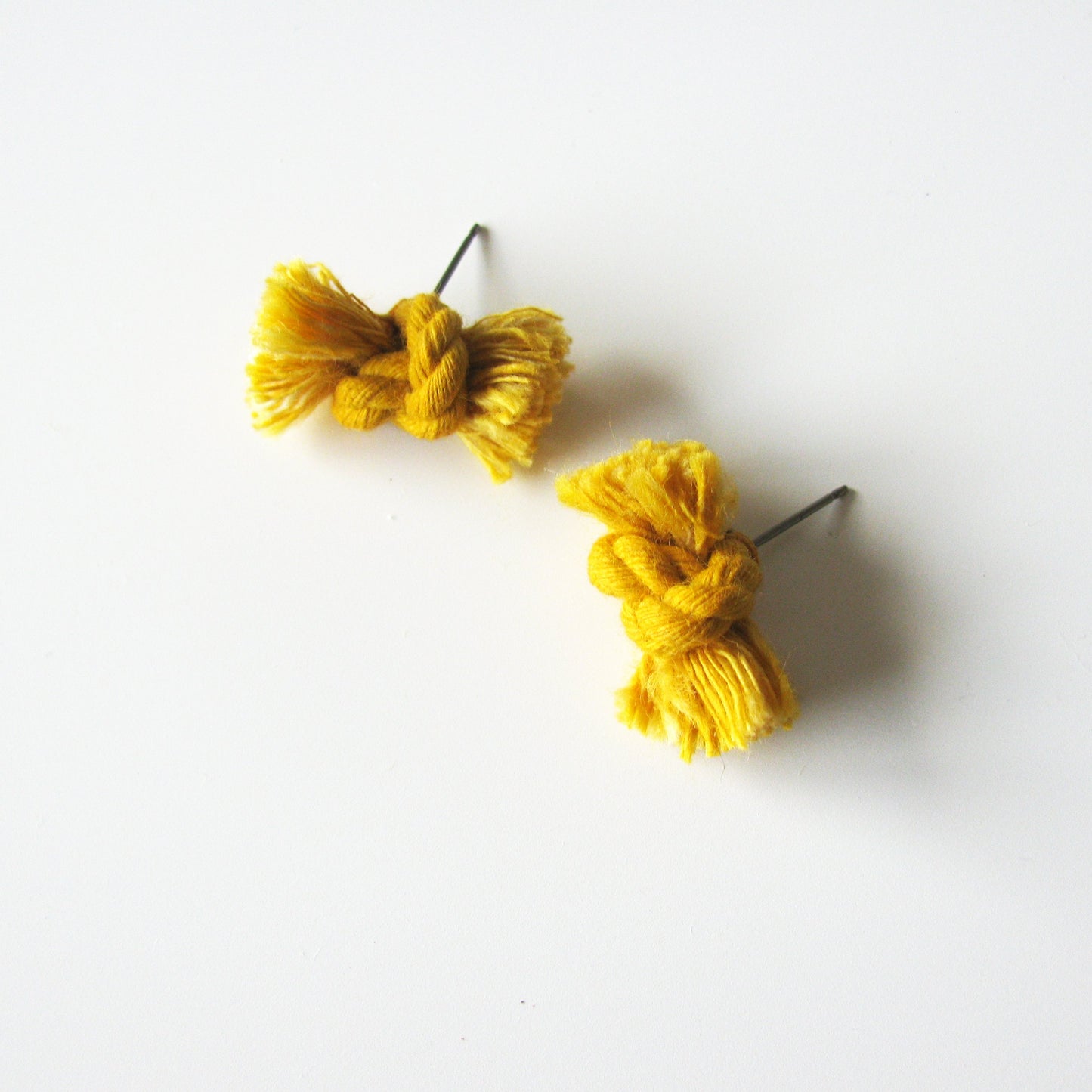Dyed cotton rope knot earrings with titanium post in marigold.