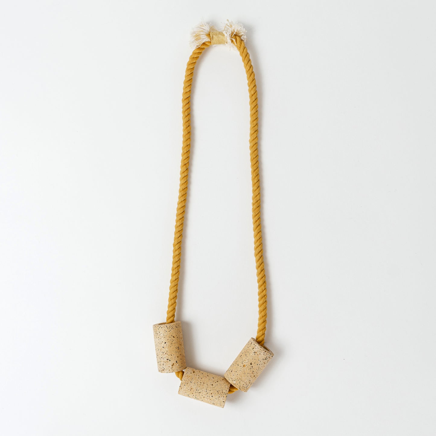 Dyed cotton rope necklace with handmade terrazzo beads in marigold.