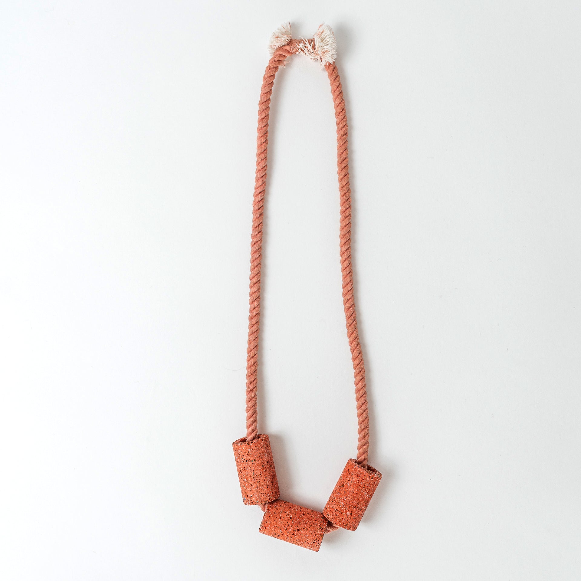 Dyed cotton rope necklace with handmade terrazzo beads in coral.