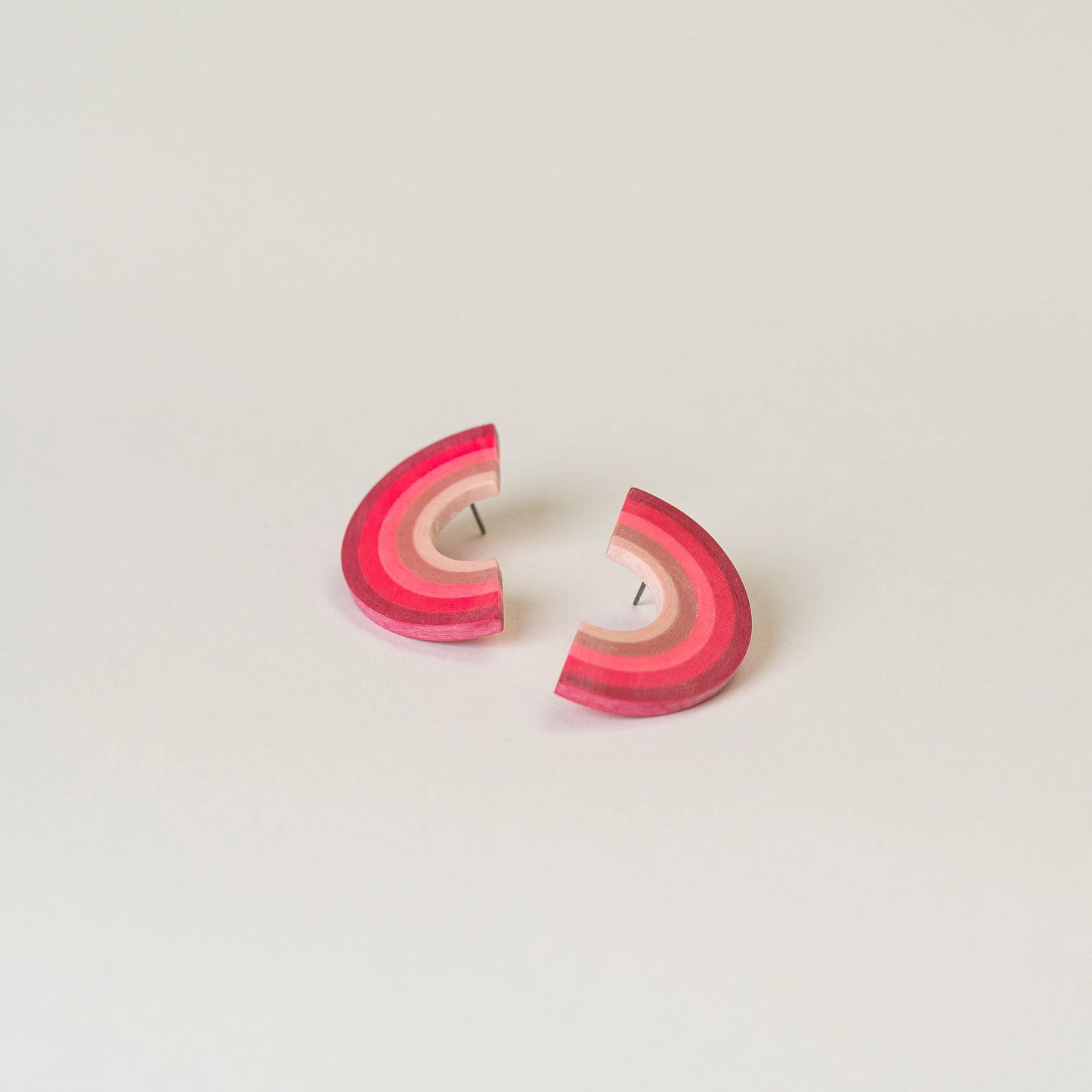 Earrings made from compressed paper with a titanium stud in pink.