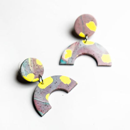Earrings are mauve and yellow polymer clay earrings with surgical steel posts.