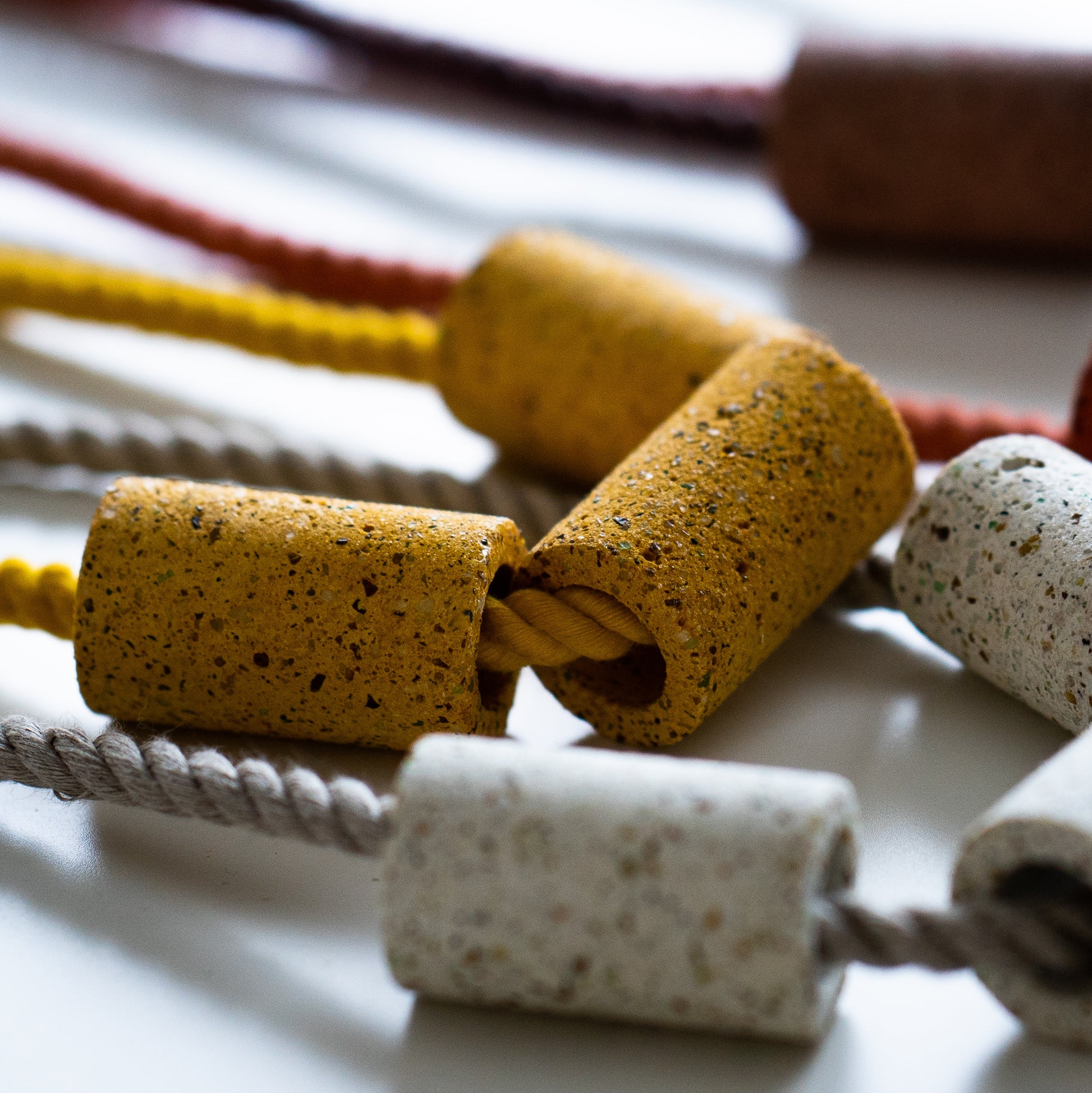 Dyed cotton rope necklace with handmade terrazzo beads. Close up photo of beads. 