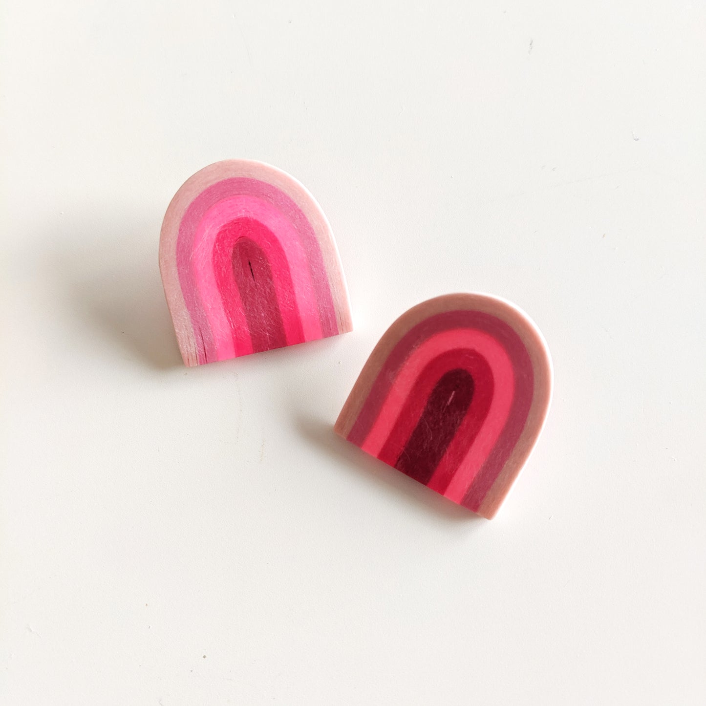 Earrings made from compressed paper with a titanium stud. Umbrella shaped in bubblegum pink color.