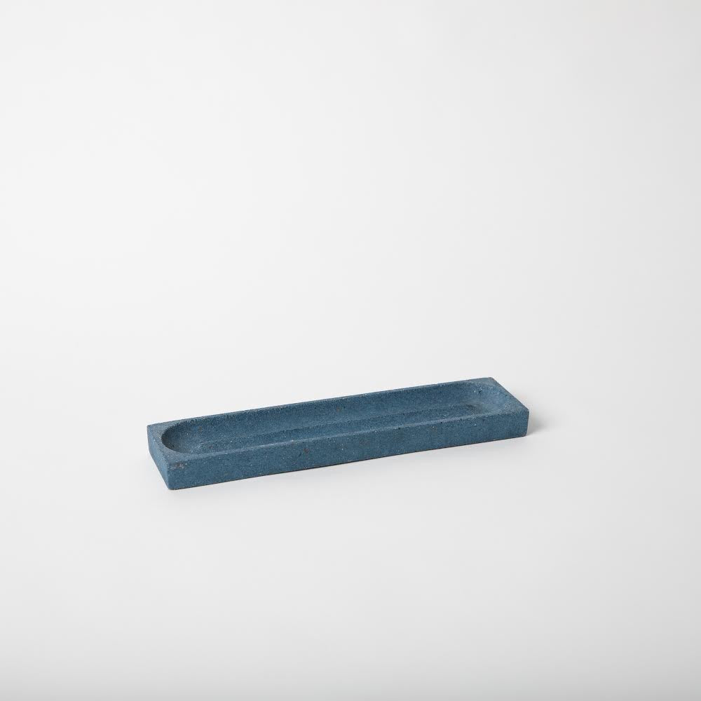 Concrete pencil tray in cobalt terrazzo.