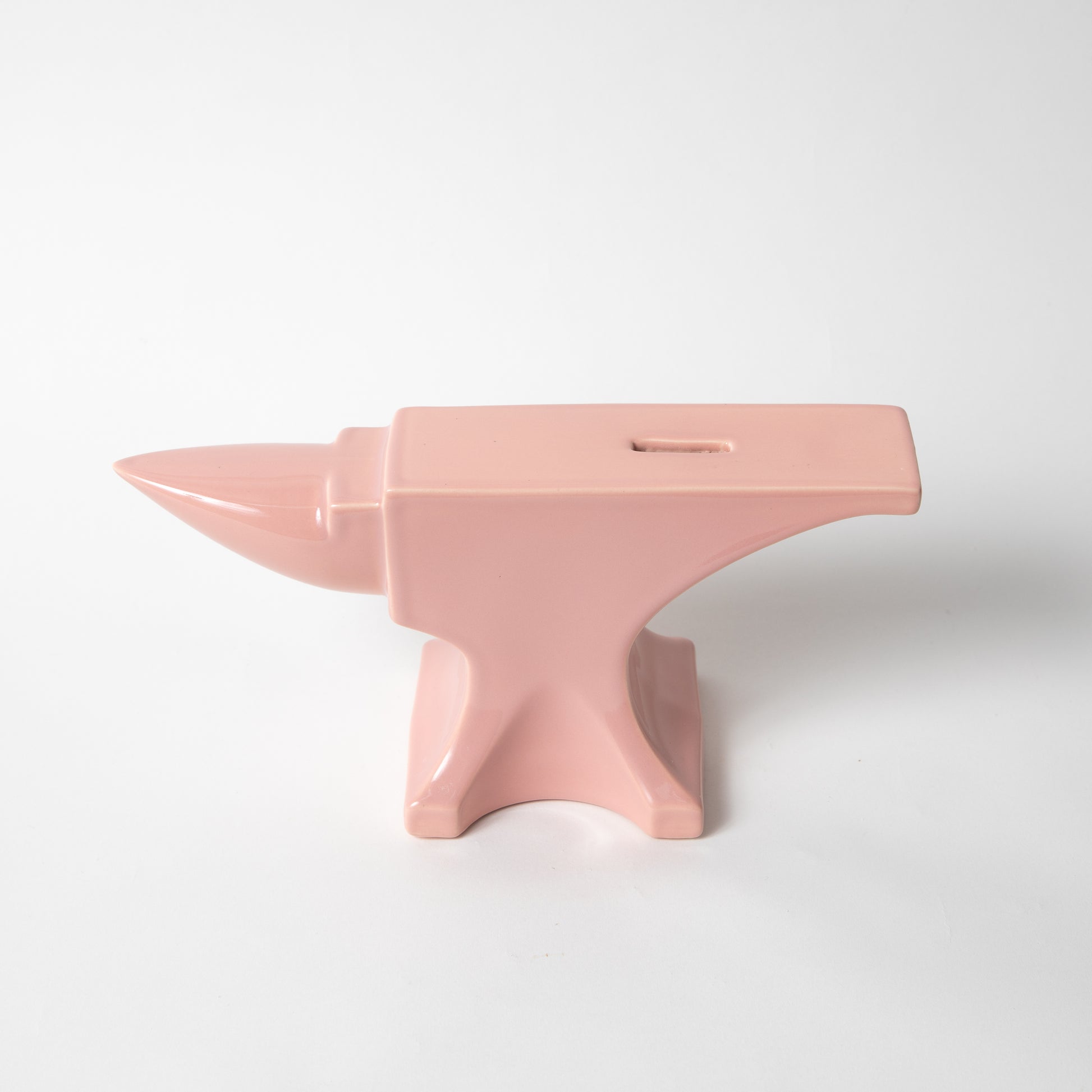 The ceramic Anvil Coin Bank in pink gloss.