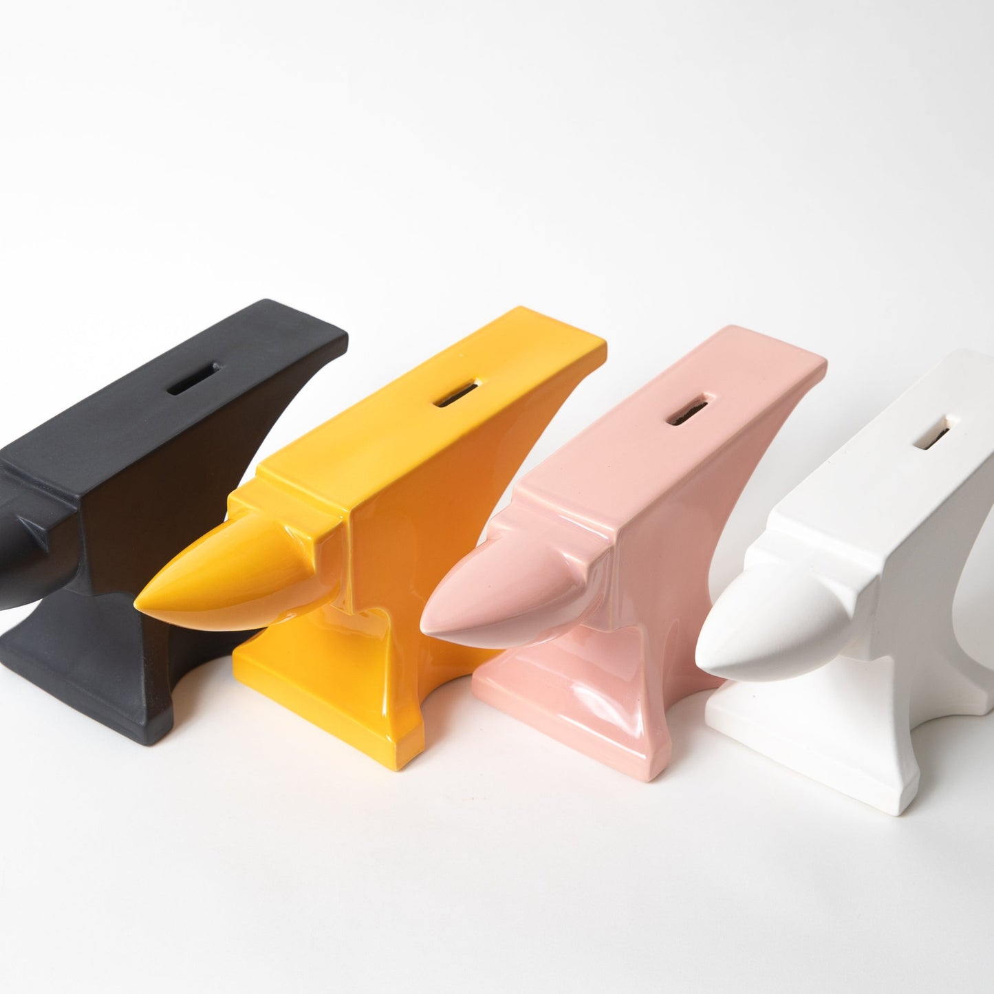 Ceramic Anvil Coin Banks in a variety of colors.