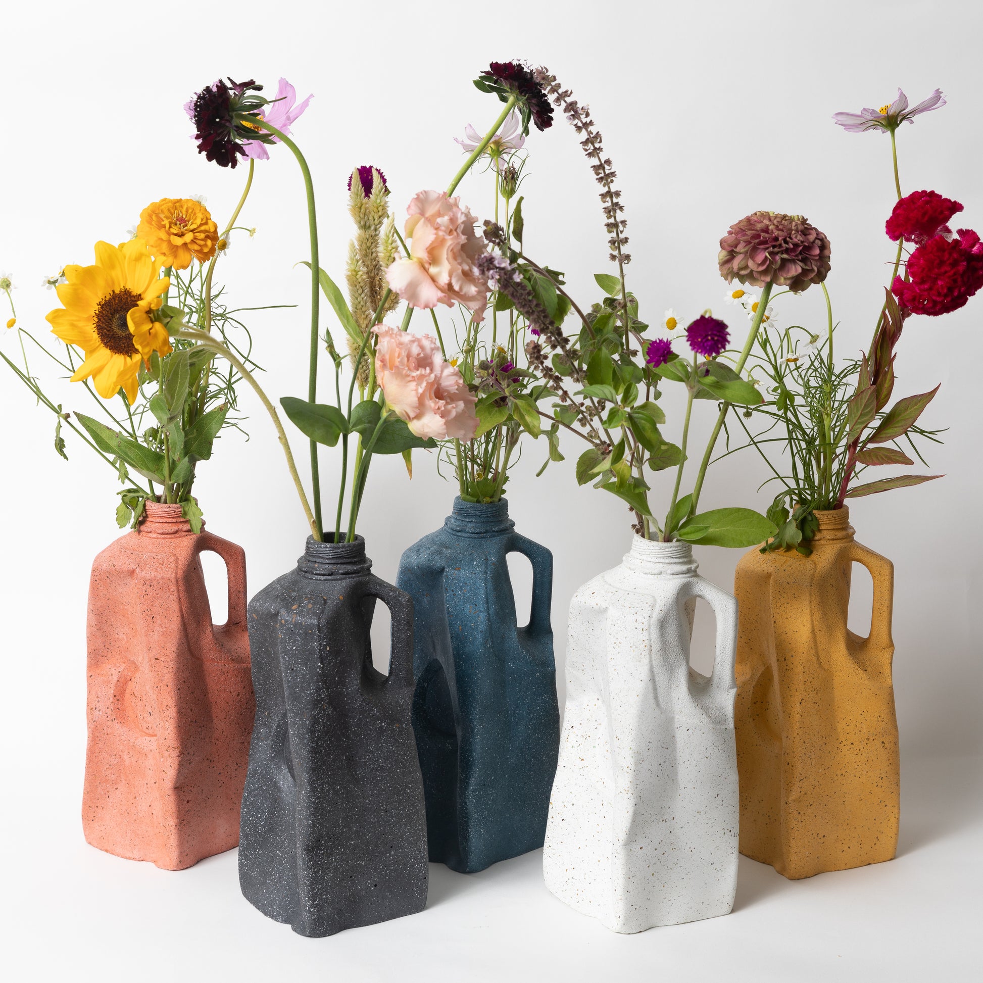 The Milk Carton Vases from our Garbage Collection, showing our terrazzo color options & styled with flowers.
