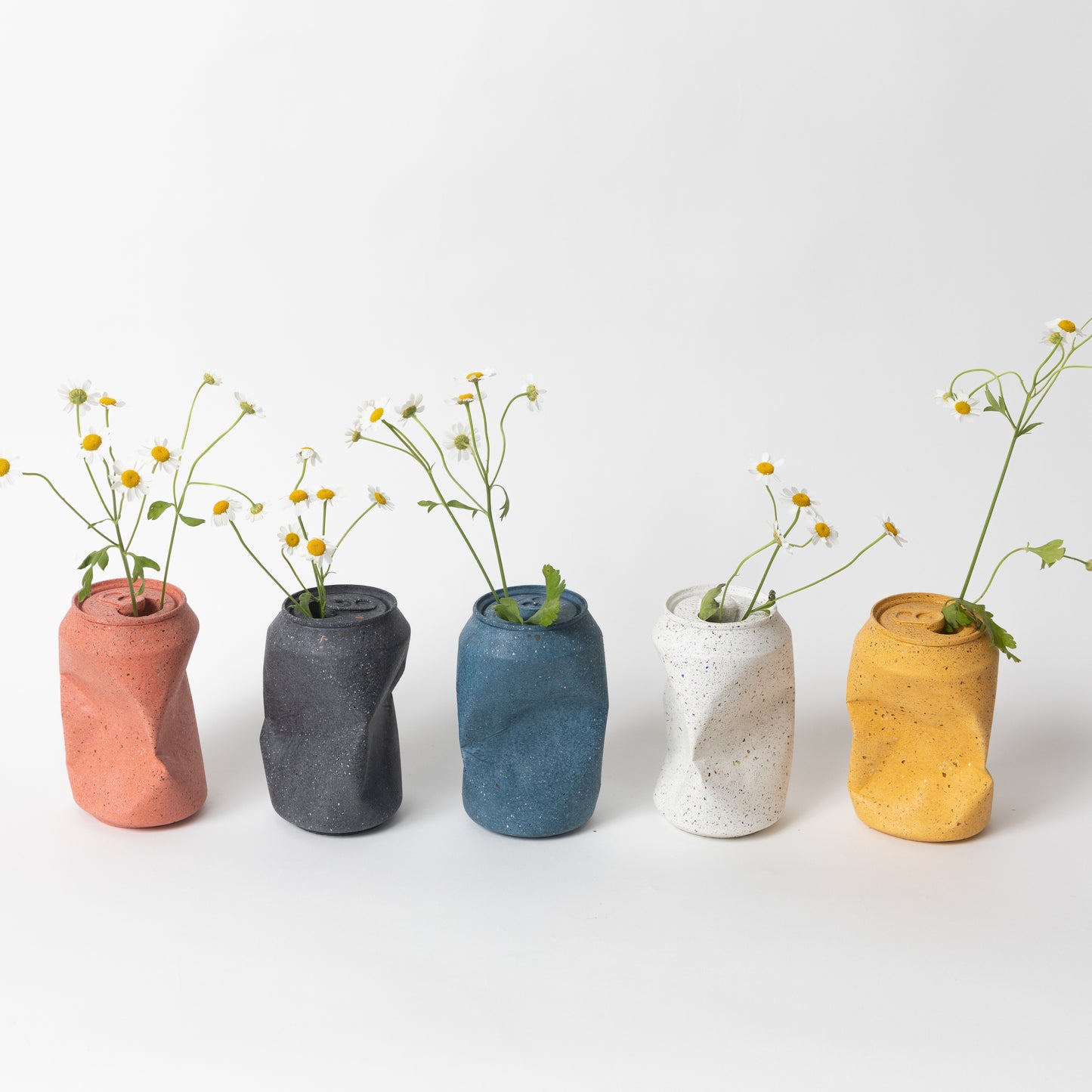 All terrazzo colorways of our soda can vases styled with flowers from our Garbage Collection.