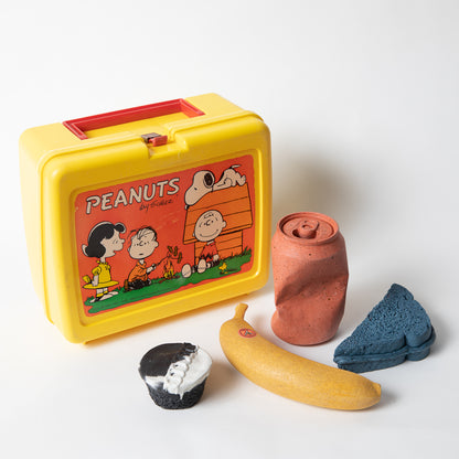Set of concrete food shaped items with vintage Peanuts lunch box