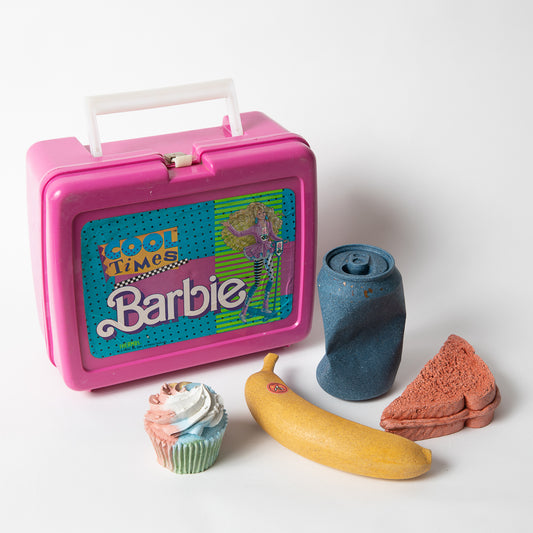 Set of concrete food shaped items with vintage Barbie lunch box