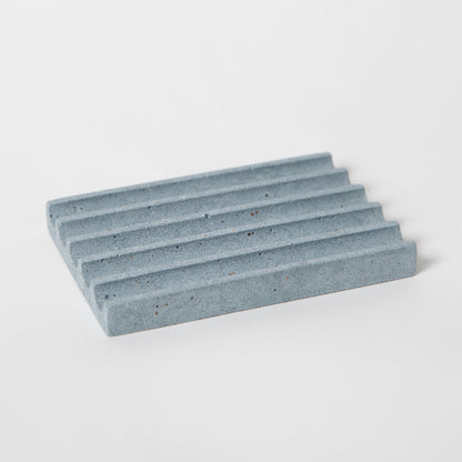 Concrete soap dish in light blue terrazzo.