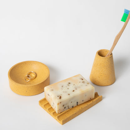 4 inch concrete catch all, soap dish, and toothbrush holder all in marigold terrazzo.