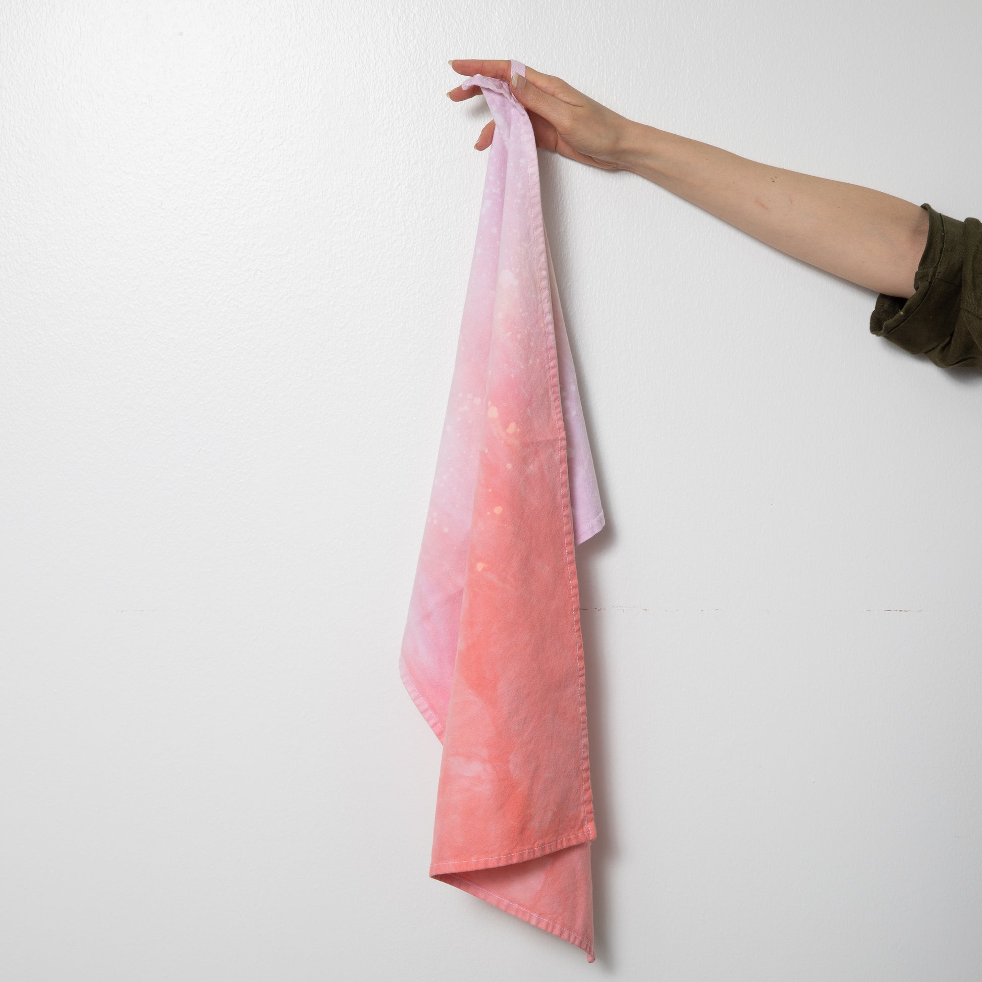 Hand dyed speckled tea towel with hang loop in pink and coral.