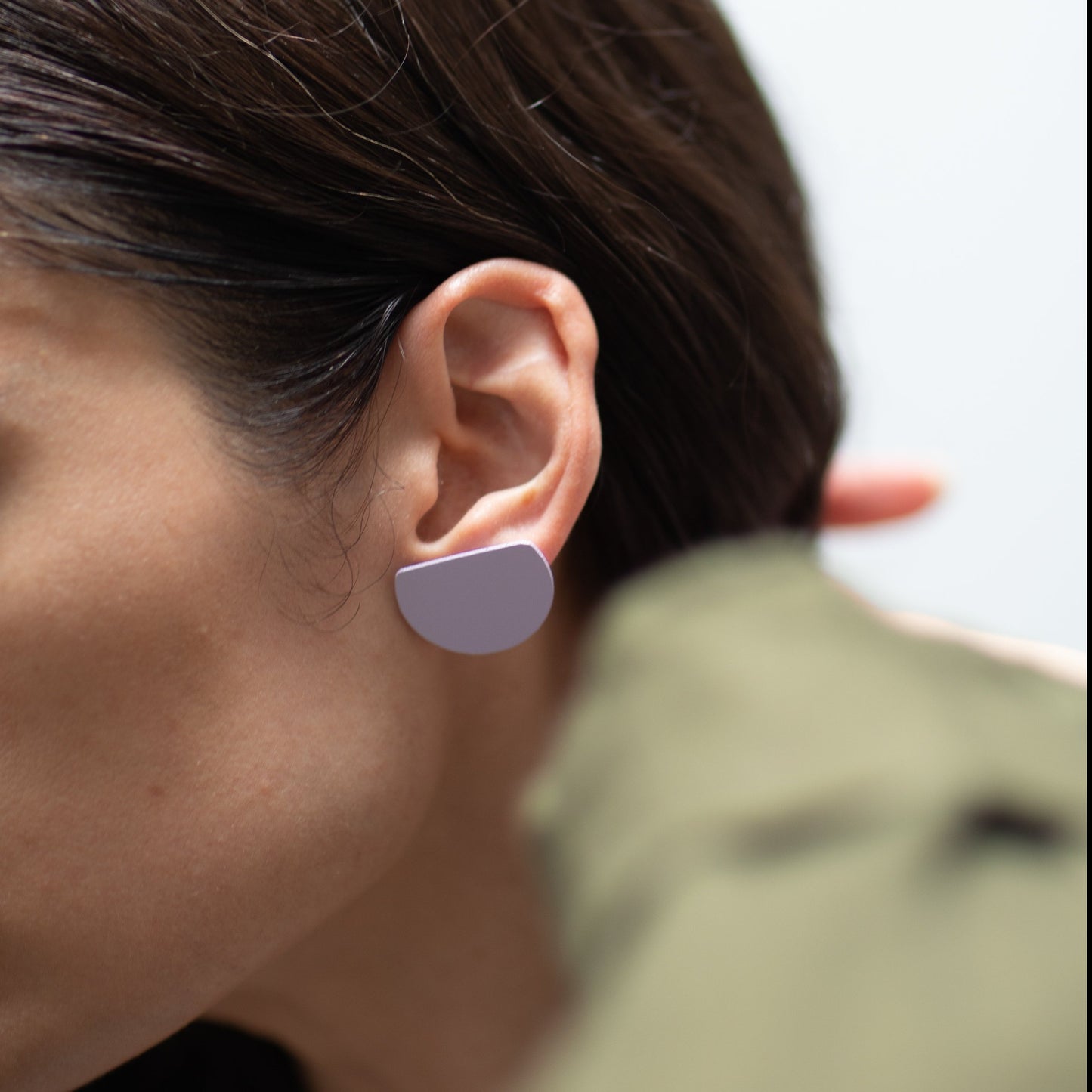 Brass w/ Sterling Posts earrings in lilac on person's ear.
