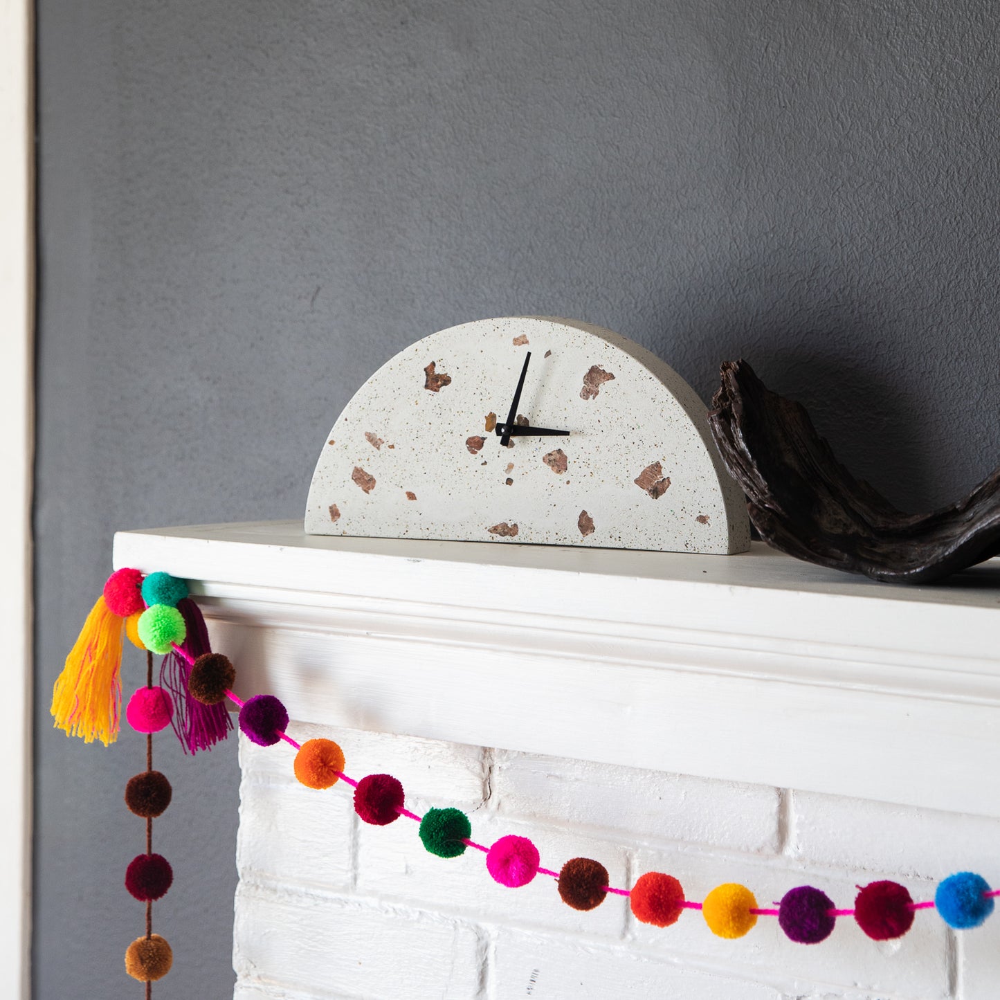 The white terrazzo mantel clock, styled on a mantel.