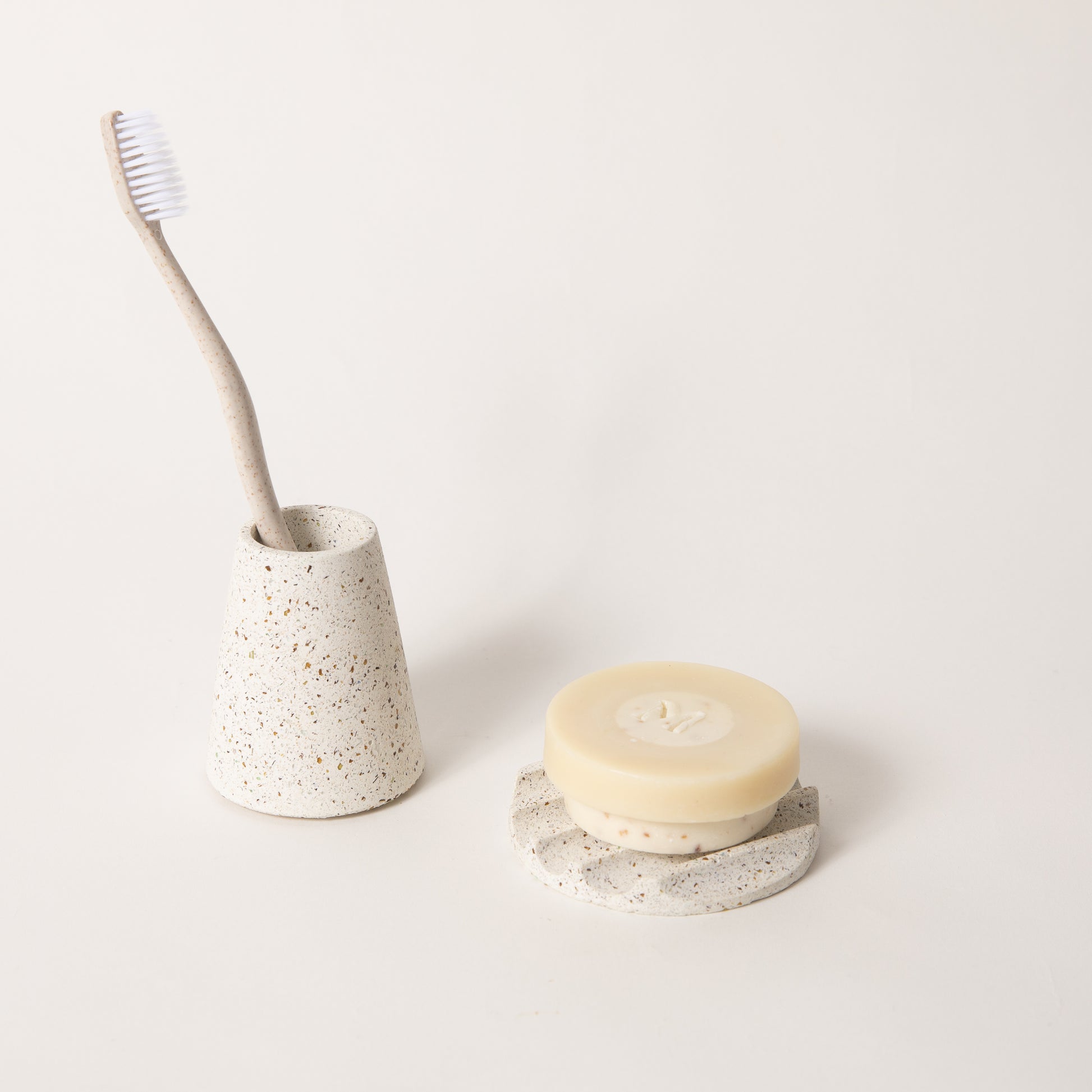 The mini soap dish & toothbrush holder set in white terrazzo.
