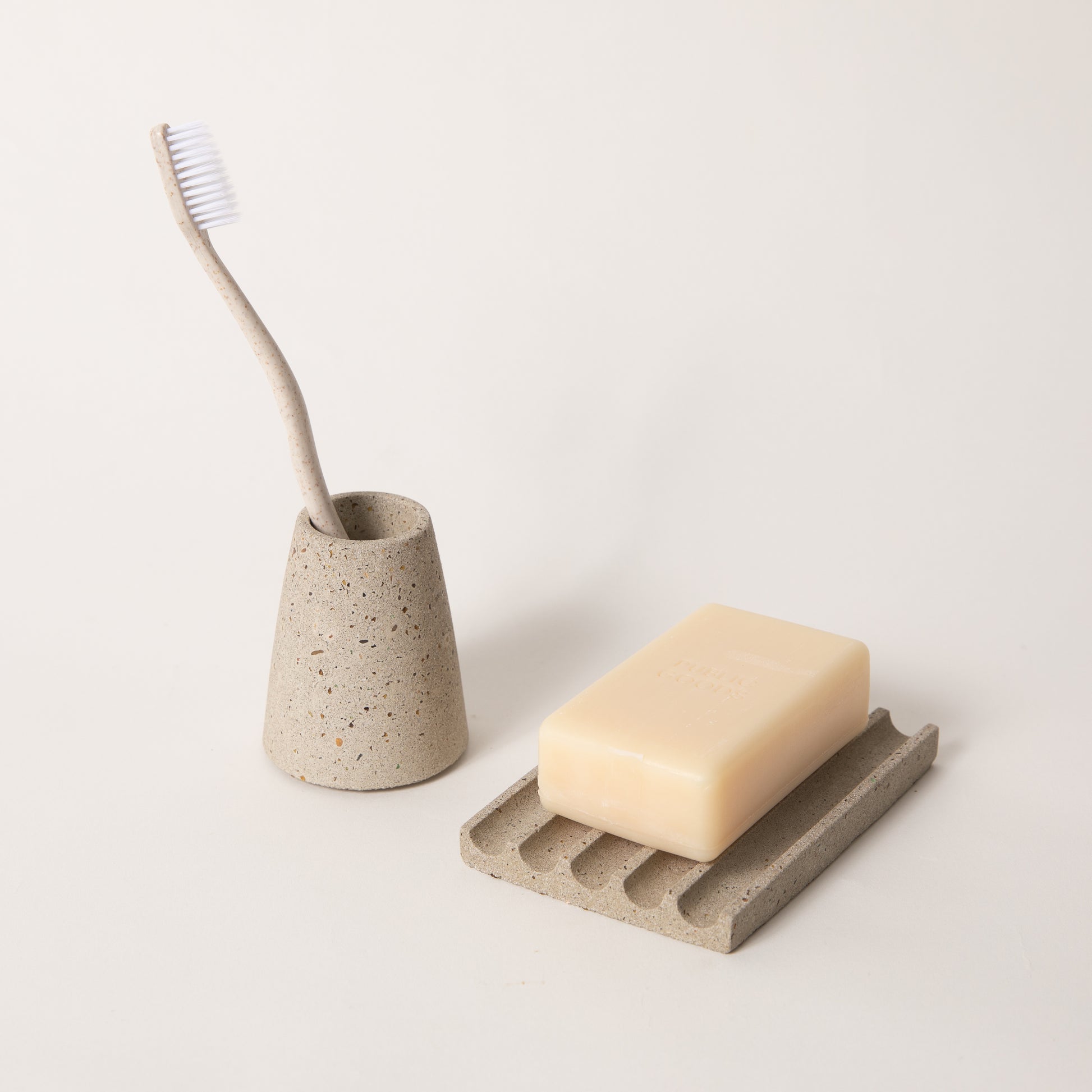 Natural terrazzo toothbrush holder & soap dish set, styled with a toothbrush & bar of soap.