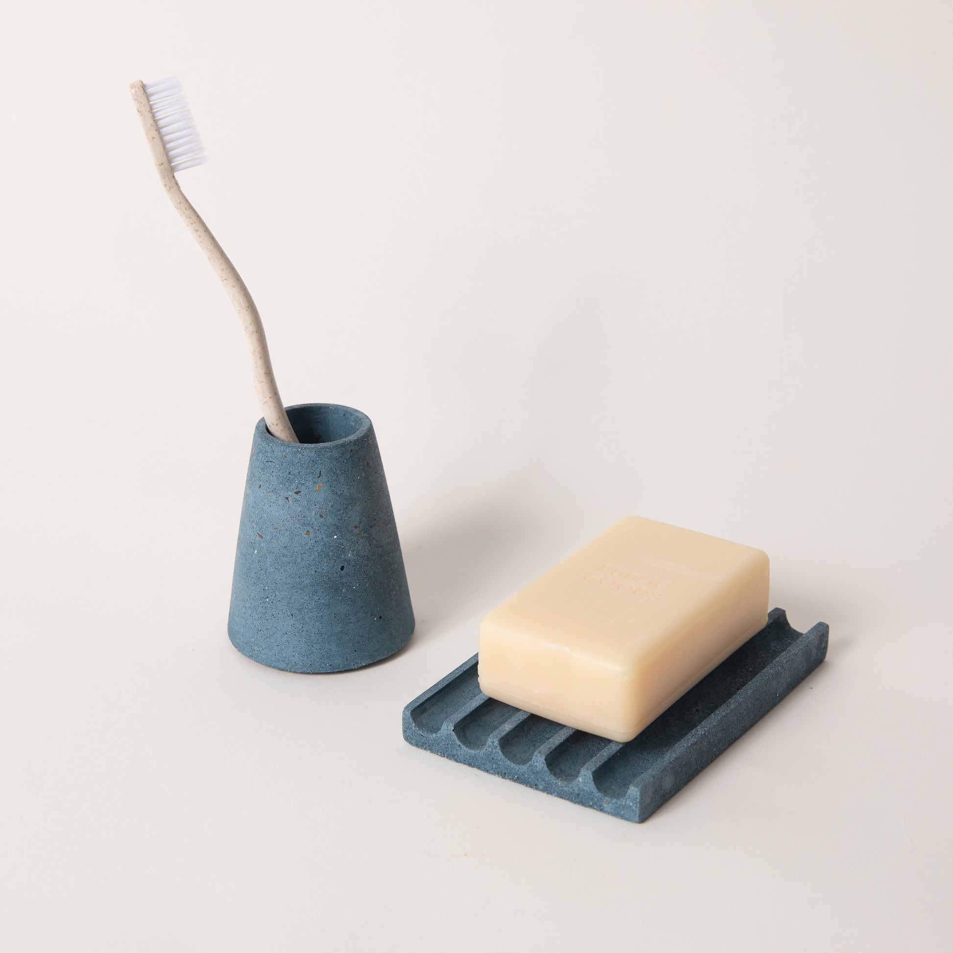 Cobalt terrazzo toothbrush holder & soap dish set, styled with a toothbrush & bar of soap.